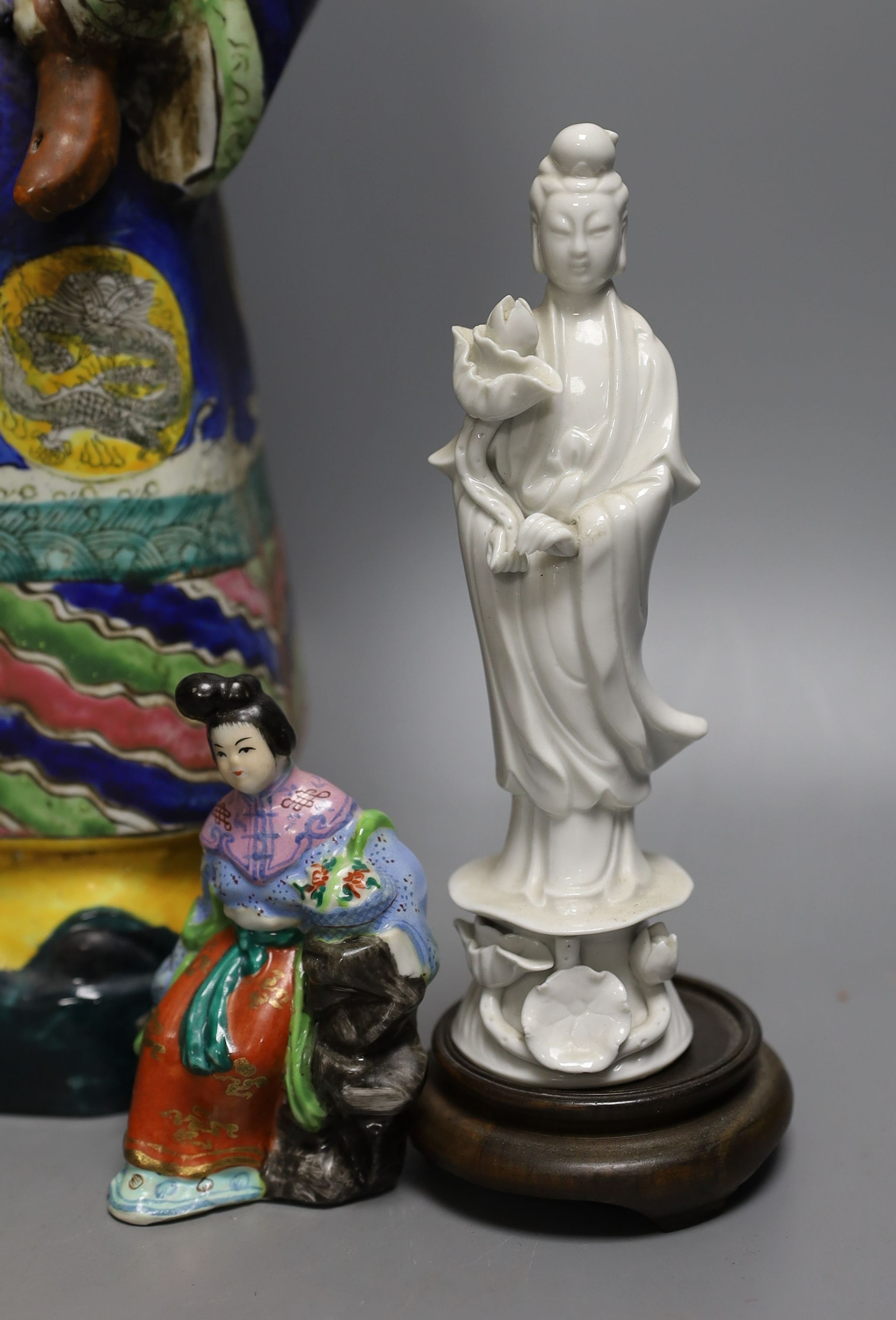 A Chinese brush pot, a pair of blanc de chine deities, a famille rose early 20th century figure, and a Kangxi emperor brush holder (5) - 45cm tall